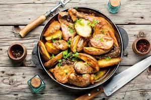 Chicken baked with potatoes in a pan,top view