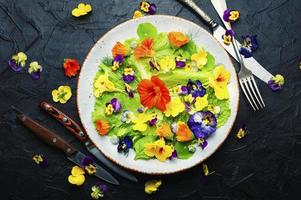 Edible flower salad in the plate photo