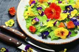 Edible flower salad in the plate photo