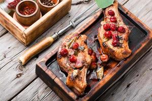 Grilled pork steaks with cherry sauce photo
