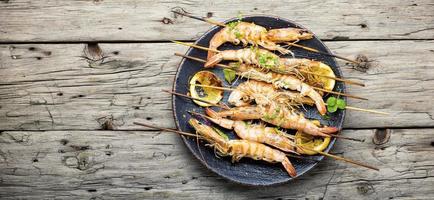 Langoustines or prawns on a skewer,space for text photo