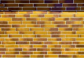 Detailed view at a colorful old and weathered brick wall texture as a panoramic background. photo