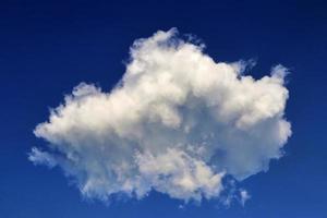 Beautiful fluffy white cloud formations in a deep blue summer sky photo