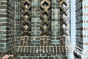 Detailed view at a colorful old and weathered brick wall texture as a panoramic background. photo