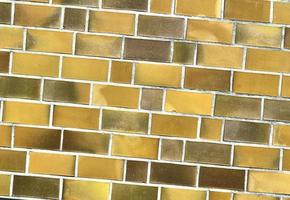Detailed view at a colorful old and weathered brick wall texture as a panoramic background. photo
