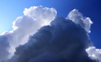 Beautiful fluffy white cloud formations in a deep blue summer sky photo