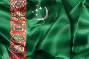 Ilustración 3d de una bandera de turkmenistán - bandera de tela ondeante realista foto