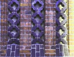 Detailed view at a colorful old and weathered brick wall texture as a panoramic background. photo