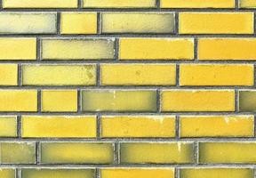 Detailed view at a colorful old and weathered brick wall texture as a panoramic background. photo