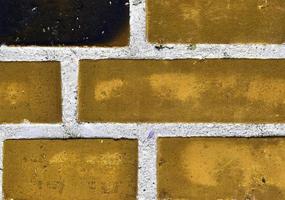 Detailed view at a colorful old and weathered brick wall texture as a panoramic background. photo