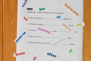 English preposition work sheet on wooden table photo