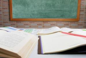 pencil over blurred textbook on table photo