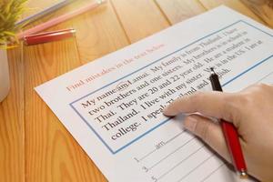 English exercise to find mistake grammar on wooden table photo