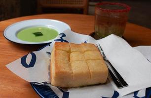 golden crunchy toast bread on plate with pandan cream photo