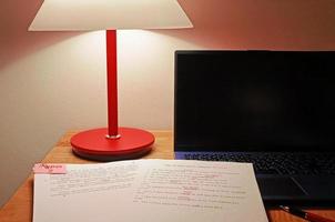 paperwork for proofreading on wooden table photo