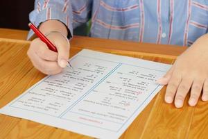 English grammar sheet on wooden table photo