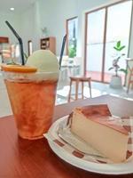 basque burnt cheesecake and cold orange tea with ice cream photo