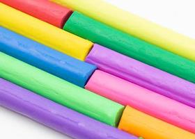multi colors of clay sticks on white photo