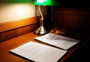 blurred proofreading paper on wooden table photo