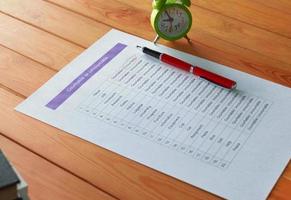 English grammar test sheet on wooden table photo