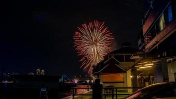 fireworks on the river in the dark sky photo