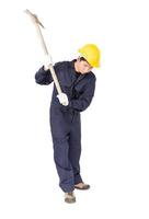 Man in uniform hold old pick mattock that is a mining device photo