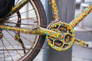 A close up colourful bicycle front derailleur in dots colour painted. photo