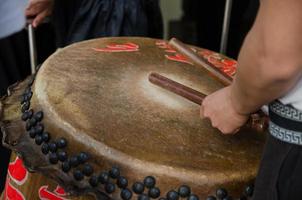 Drumsticks beating on a Chinese traditional drum. photo