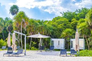 Palms parasols sun loungers beach resort Playa del Carmen Mexico. photo