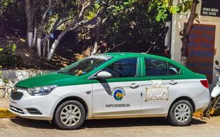 Puerto Escondido Oaxaca Mexico 2022 Green turquoise blue taxi cab car in Puerto Escondido Mexico. photo