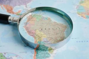 Bangkok, Thailand - May 15, 2022 Magnifying glass on world map. photo