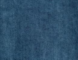 Blue denim jeans textile background. Faded blue jeans. Denim fabric photo