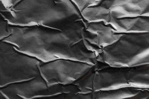 black crumpled and creased plastic poster texture background photo