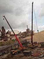 two cranes operating at the mine site good for lifting heavy objects photo