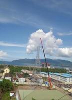 crane car operating at mine site with blue sky and white clouds photo