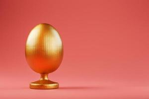 Golden egg on a pink background with a minimalistic concept. photo