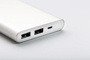 Powerbank for charging mobile devices with cable, on a white background. photo