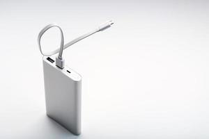 Powerbank for charging mobile devices with cable, on a white background. photo