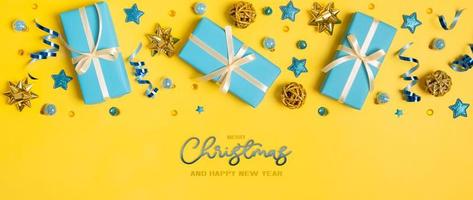 Merry Christmas and Happy New Year greeting banner with Christmas gifts and decorations top view, flat lay photo