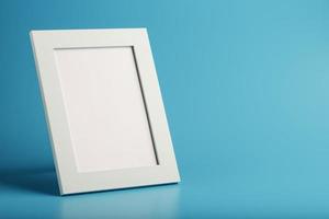 White and black photo frame with empty space on a blue background.