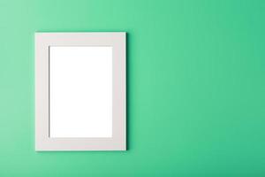 White photo frame with an empty space on a green background.