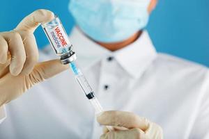 Vaccine ampoule in the hands of a physician researcher. photo