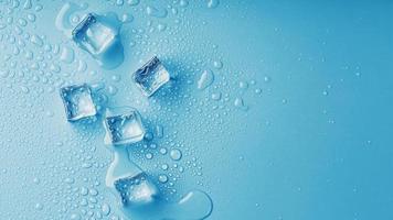 Ice cubes with water drops scattered on a blue background, top view. photo