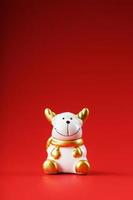 Ceramic Christmas cow bull toy on a red background. photo