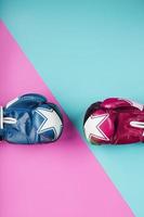 Boxing red and blue glove on a blue and pink background diagonally photo