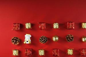 Christmas decorations and a toy cow on a red background. photo