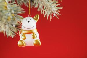 Bull figure on a Christmas tree on a red background, free space for text. photo