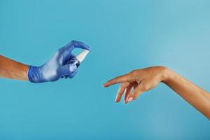 Hand sanitizer on a blue background. The concept of prevention and prevention of the spread of viruses, infections, coronavirus diseases. photo