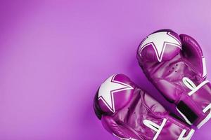 Pink Boxing gloves on a pink background, free space. photo