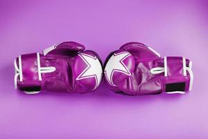 Pink Boxing gloves on a pink background, free space. photo